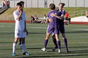 Nate Blanchard is embraced by his teammates after heading in a late, decisive goal against Fife on May 12. Jacob Moore | Kitsap Daily News