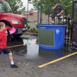 Deputy Chief Guy Dalrymple of South Kitsap Fire and Rescue gets ready to be dunked following a spot-on throw by this youngster at the May 19 Safety and Bicycle Rodeo event in Port Orchard. (Bob Smith | Kitsap Daily News)