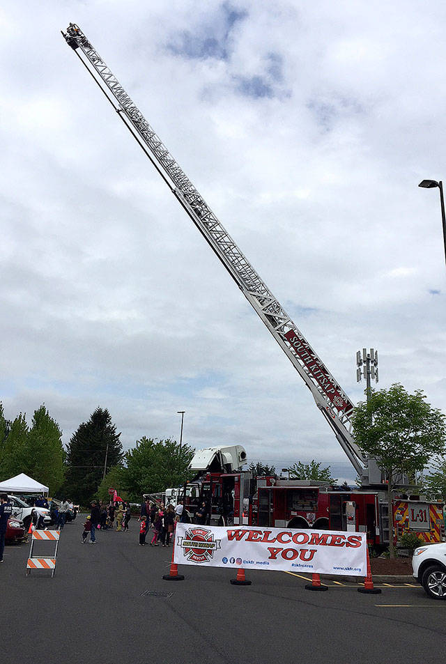 This could qualify as a fold-out photo of the month for a 9-year-old youngster  a South Kitsap Fire and Rescue ladder truck reaching to the sky. Apparatus and equipment from the fire department, as well as from Port Orchard Police, Washington State Patrol and Kitsap County Sheriffs Office, were on hand to see and touch at the Safety Fair and Bicycle Rodeo May 19 in Port Orchard. (Bob Smith | Kitsap Daily News)