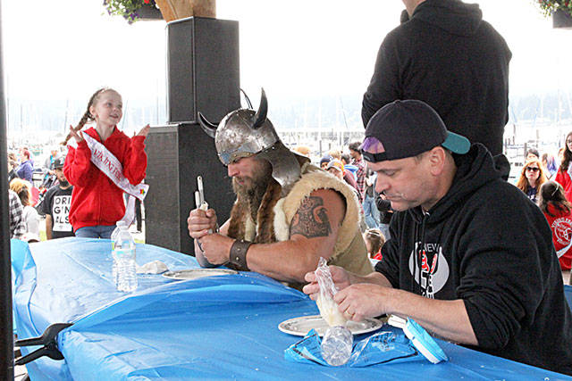 The lutefisk eating competition was a central feature of Sundays festivities. Little Miss Viking Fest Everlee Brenton cheers on as Brennan Webster and Tim Leary compete in the final round of the competition. Nick Twietmeyer / Kitsap News Group