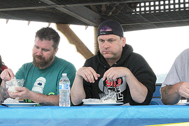 Dave Lambert, a seasoned lutefisk veteran and Tim Leary, who had never tried lutefisk before Sundays lutefisk eating competition, exhibit the polarizing flavor profile of the Scandinavian dish. Nick Twietmeyer / Kitsap News Group