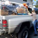 With dad Jeremys help, Shelby Beveridge loads up her donated items for delivery to Georgias House, a battered womens shelter. (Contributed photo)