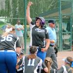 Morgan Kroesser bowls over her teammates after a first-inning grand slam against Lynden. Unfortunately, Lynden would end up with a 14-6 victory. (Mark Krulish/Kitsap News Group)