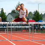 Deyondre Davis clears the final hurdle in the 300-meter event. He took third in that race and second in the 110-meter hurdles. (Mark Krulish | Kitsap Daily News photo)