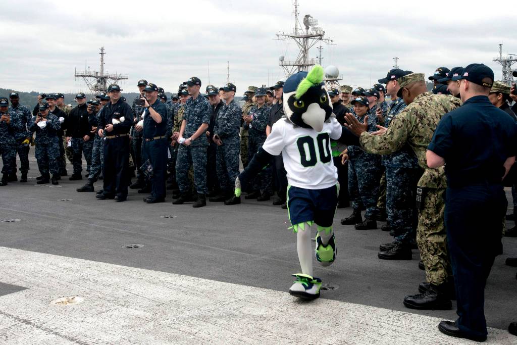The Seattle Seahawks football team mascot, Boom, greets Sailors aboard the aircraft carrier USS John C. Stennis (CVN 74). Stennis is pier-side after returning to homeport after the completion of a seven-week underway where the ships crew completed TSTA/FEP early and Carrier Strike Group 3 Group Sail in preparation for its next scheduled deployment.                                Mass Communication Specialist Seaman Isabel Birchard / U.S. Navy