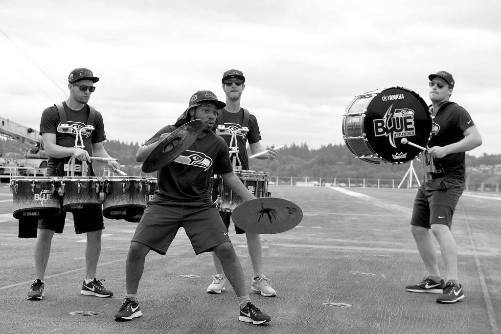 The Seattle Seahawks drumline, Blue Thunder, performs aboard the aircraft carrier USS John C. Stennis (CVN 74). The Seattle Seahawks football team and Sea Gals cheerleaders held a military appreciation event aboard to meet and talk with sailors.                                Mass Communications Specialist Seaman Angelina Grimsley / U.S. Navy