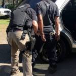 An unidentified man is arrested and detained by a Kitsap County Sheriffs Office deputy June 2 at the site of the cockfighting operation in South Kitsap. (Kitsap County Sheriffs Office photo)
