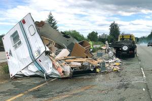<em>A trailer that had just been purchased in Poulsbo by an Auburn woman and her male passenger flips over on State Route 3 near Trigger Ave. in Silverdale.</em> Photo courtesy of Washington State Patrol Trooper Chelsea Hodgson