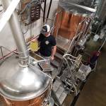 <em>Stephen Shively adds the all-important hops to a tank at Rany Daze Brewing. </em>