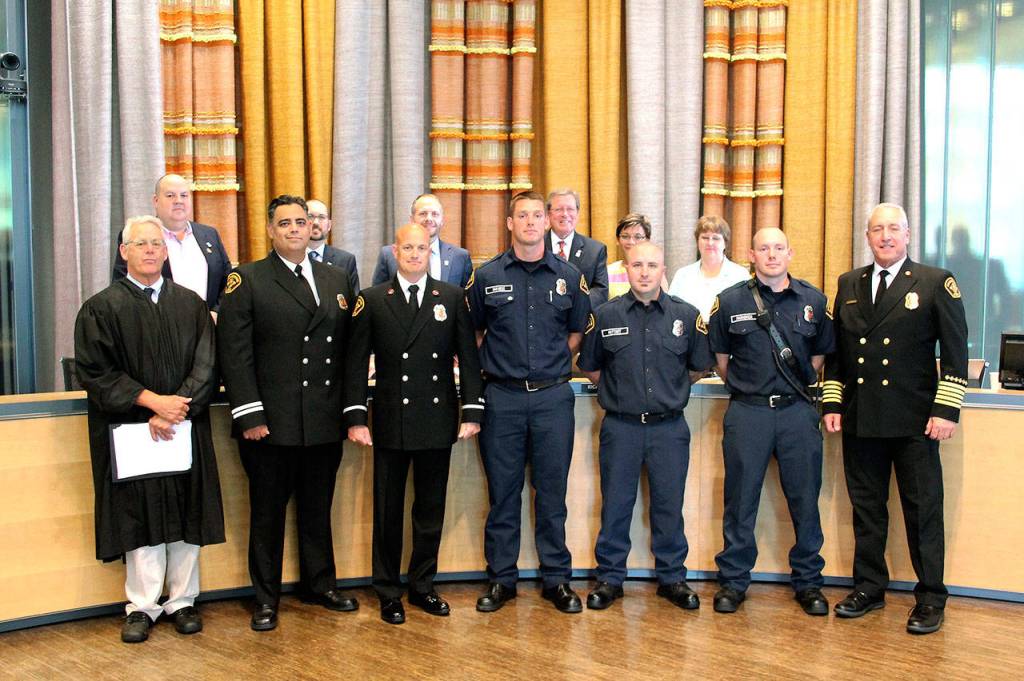 Capt. Ricardo Valdez, Lt. Jeff Prichard, Kurt Van Ness, Rickey Muttart, Evan Markovich, and Chief David Schmitt stand in front of the Bremerton City Council. (Mark Krulish/Kitsap News Group)