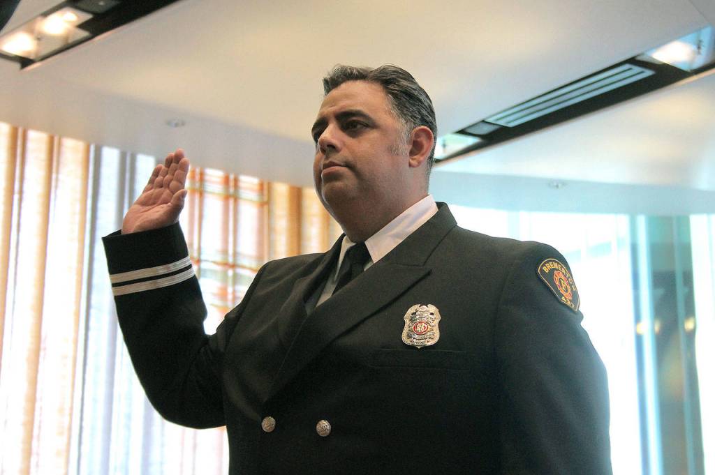 22-year veteran Capt. Ricardo Valdez takes the oath for his new position. He was promoted to captain in June. (Mark Krulish/Kitsap News Group)