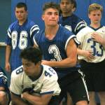 Junior quarterback Zeke Gillick hands off to his running back during an indoor practice. (Mark Krulish/Kitsap News Group)