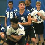 Junior quarterback Zeke Gillick hands off to his running back during an indoor practice. (Mark Krulish/Kitsap News Group)