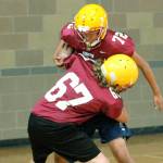 Kingston players practiced wrapping up the ball carrier  without doing any actual tackling  during an indoors practice on Aug. 21. Poor air quality has kept teams inside for the most part this season. (Mark Krulish/Kitsap News Group)