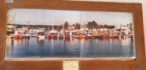 A photo from the 1990 of the Poulsbo Boat Rendezvous sees a number of Youngs characteristic boat moored at the Port of Poulsbo.