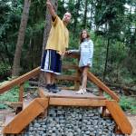 Jesse Arellano and his daughter Aliyah climb aboard a small platform at the new nature trail at South Kitsap Regional Park. (Bob Smith | Kitsap Daily News)