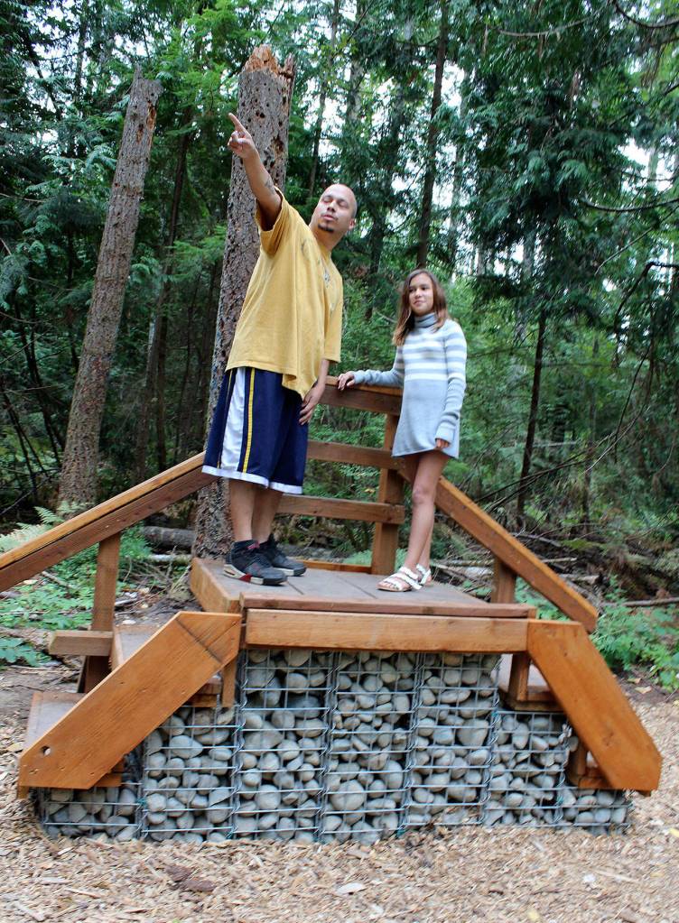 Jesse Arellano and his daughter Aliyah climb aboard a small platform at the new nature trail at South Kitsap Regional Park. (Bob Smith | Kitsap Daily News)