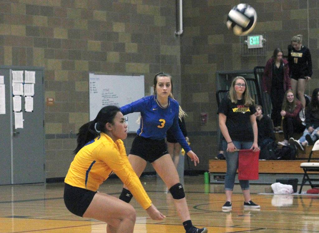 Bremertons Patricia Reyes digs out a spike while teammate Jennifer Kielley looks on. (Mark Krulish/Kitsap News Group)