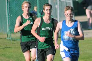 Klahowyas Jaeden Ellis (left) and Alex Oathout (middle) chase North Masons Noah Hasselblad. (Mark Krulish/Kitsap News Group)