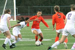 Ailin Zhang, one of two freshmen starting at forward for Central Kitsap, tries to dribble through the North Thurston midfield during her teams 1-0 win on Sept. 27. (Mark Krulish/Kitsap News Group)
