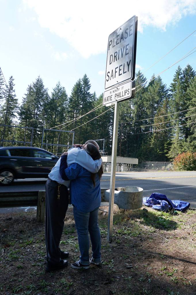 Harrah and Olwell embrace at the end of the roadside unveiling ceremony Oct. 4. (Bob Smith | Kitsap Daily News)