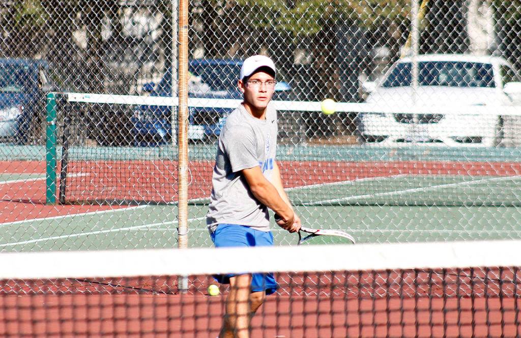Zachary Wyant returns serve for Olympic High School at the league tennis championships. (Mark Krulish/Kitsap News Group)