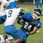 Olympics Clayton Talarico tries to break free from Bremertons Hector Infante early in the Trojans 34-27 win. (Mark Krulish/Kitsap News Group)
