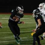Hunter Wallis looks for a hole in the Cascade Christian defense in Thursday nights 44-28 loss. (Mark Krulish/Kitsap News Group)