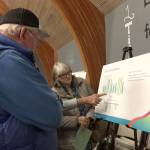 A capacity crowd reviews Washington State Ferries charts detailing a revised sailing schedule for the Triangle sailings among the Southworth, Vashon and Fauntleroy ferry terminals. (Bob Smith | Kitsap Daily News photo)