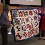 Gateway teachers Bill Parrot and Linda Hemry show off the quilt of valor made by Hemry to be presented to Mitchell.