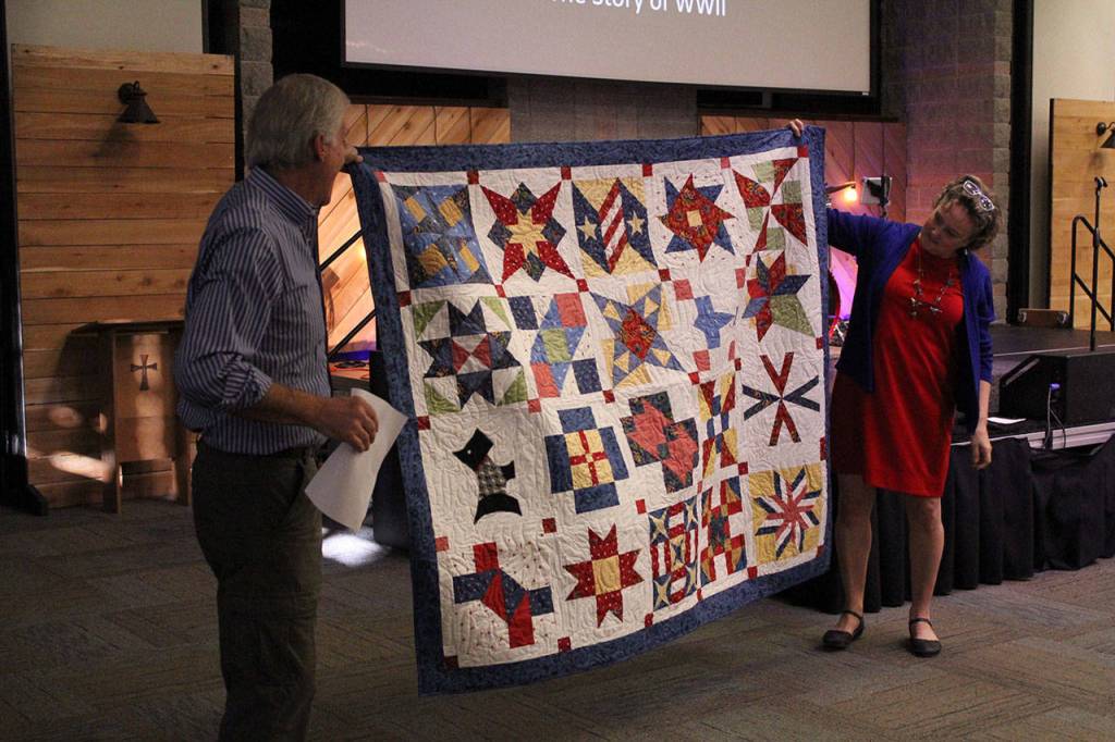 Gateway teachers Bill Parrot and Linda Hemry show off the quilt of valor made by Hemry to be presented to Mitchell.