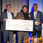 Nick Taylor (center) of Dragonfly Cinema in Port Orchard accepts the $5,000 cash prize for winning the Community edg3 Award. Flanking Taylor is Tony George, president and COO of Kitsap Bank (left) and Steve Politakis, Kitsap Bank CEO. (Kitsap Bank photo)
