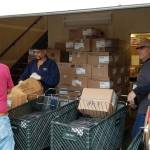 <em>Volunteers and workers at Kingstons Sharenet work to distribute boxes containing Thanksgiving dinner supplies on Nov. 16. One volunteer estimated he had delivered 1,000 pounds worth of turkey for distribution. </em>                                Nick Twietmeyer/Kitsap News Group