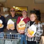 <em>Nathaniel Hibbler, Christopher St. Romain, Bob McNamara and Sherri Luxon work to distribute Thanksgiving dinners for families in need at Kingstons Sharenet on Nov. 16.</em>                                Nick Twietmeyer/Kitsap News Group<em></em>