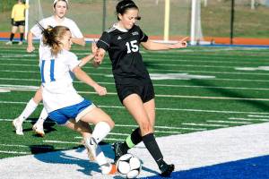 Kate Streck (15) battles for the ball with Deer Parks Carmen Kiewert during the 1A state tournament third place game. (Mark Krulish/Kitsap News Group)