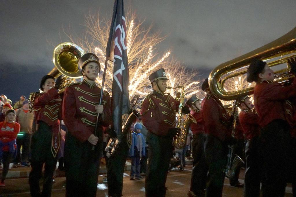 South Kitsap High Schools marching band lends the sounds of the holidays as Santa Claus, along with Mrs. Claus, follows behind the band in a vintage fire engine. (Bob Smith | Kitsap Daily News)