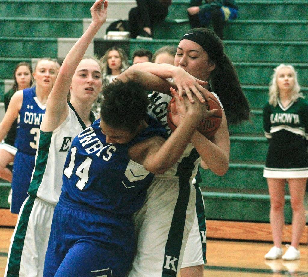 Eagles center Kayla Hendricks and Chimacums Diamond Young (14) battle for a rebound. (Mark Krulish/Kitsap News Group)