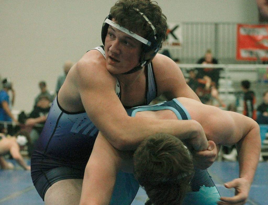 Cache Holmes of North Kitsap takes on Simon Atwell of Gig Harbor. (Mark Krulish/Kitsap News Group)