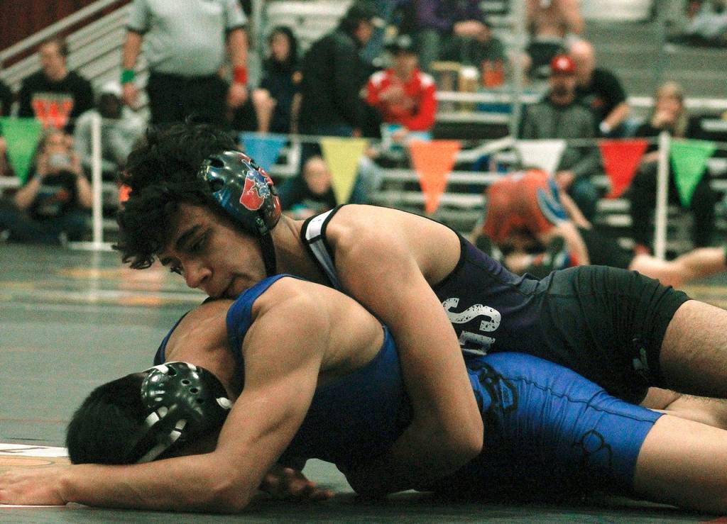 Robert Gomez of North Kitsap is a semifinalist at this years event. Here, he defeats Domingo Pedro-Gaspar of North Mason in a 9-2 decision. (Mark Krulish/Kitsap News Group)