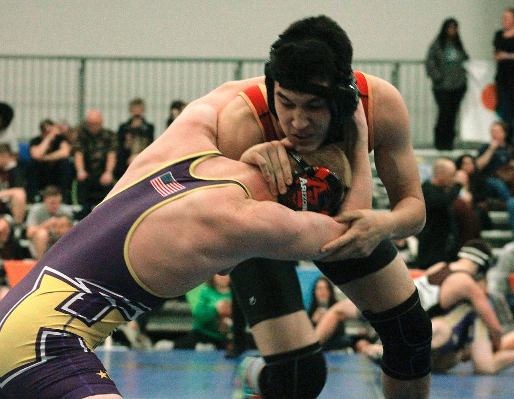 Kingstons David Jensen squares off with Carter Murphey of Hanford in the 152-pound division. (Mark Krulish/Kitsap News Group)