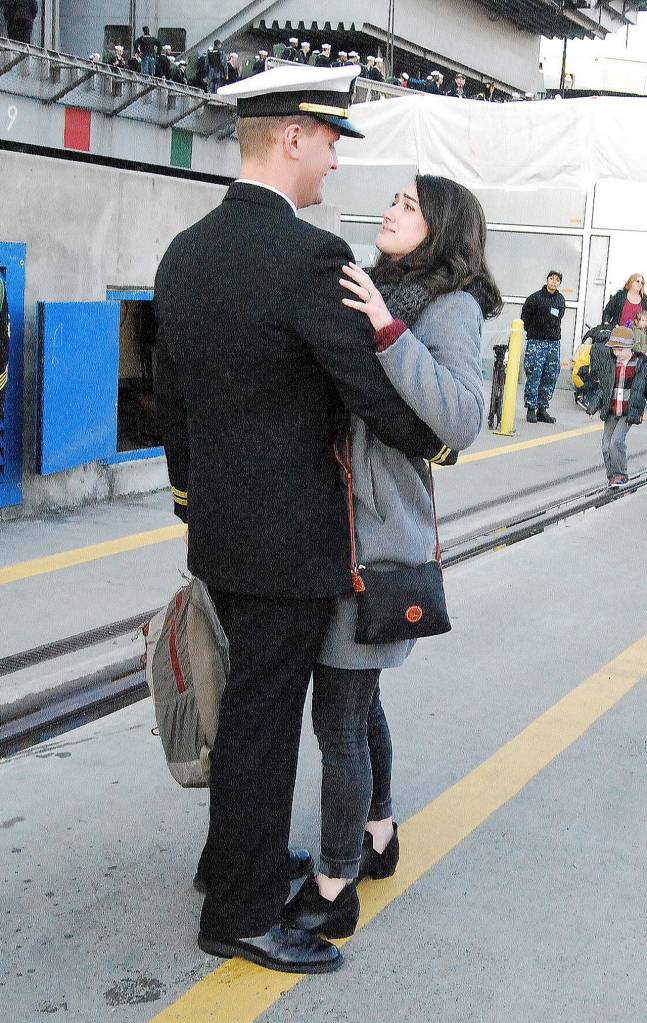 Holly graciously allowed this photographers peering lens to watch in (at a respectable distance) as she awaited her new husbands arrival. When loudspeakers at dockside began playing Meghan Trainors Christmas song Ill Be Home, tears began to flow for the new wife, a nurse at Madigan Medical Center  as they undoubtedly did for hundreds of others also awaiting a loved ones arrival.                                And as it happens at the end of all fairy tales, the newly reunited couple kissed and hugged at the bottom of the gangway. It was the end of a beautiful story  and an eventful year in photos in South Kitsap.