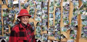 Elda Armstrong showcases her gallery. Each visitor that purchases a Christmas tree from St. Micks has their photo taken and placed on a wall for display next year. Nick Twietmeyer / Kitsap News Group