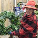 Armstrong shows off one of her handmade Pacific Northwest wreaths. Nick Twietmeyer / Kitsap News Group