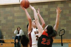 Kingston freshman Ellee Brockman tries to put a shot over Central Kitsaps Alexandra Neumann. (Mark Krulish/Kitsap News Group)