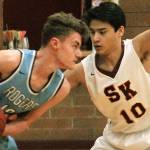 South Kitsaps Josh Potz (10) closely guards Nick Hansen of Rogers in his teams 47-37 win. (Mark Krulish/Kitsap News Group)                                South Kitsap senior DeAnte Ward swings the ball across the floor. Ward scored a game-high 18 points against Rogers. (Mark Krulish/Kitsap News Group)