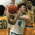 <em>Brandon Barron (4) attempts to slice between two Bremerton defenders during a Jan. 15 matchup</em> Mark Krulish/Kitsap News Group