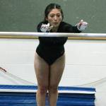 Kelli Stevens makes the leap for the uneven parallel bars. (Mark Krulish/Kitsap News Group)