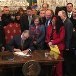 Gov. Jay Inslee signs the first bill of the 2019 Legislative Session into law on Monday, Feb. 4. Photo by Sean Harding.