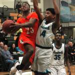 Elijah McGee drives the basket against Spanaway Lakes Jarrod Wright-DAbreau (14) during Central Kitsaps second quarter 13-2 run. (Mark Krulish/Kitsap News Group)