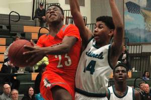 Elijah McGee drives the basket against Spanaway Lakes Jarrod Wright-DAbreau (14) during Central Kitsaps second quarter 13-2 run. (Mark Krulish/Kitsap News Group)